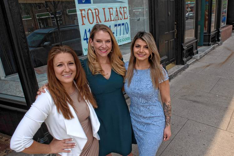 Christina Webster, owner of Priceless Picnic, Dr. Megan Allen, owner of Community Classroom and Amanda Shafii owner of CopyCat, are all co-creaters of The Sphere, stand in front of a vacant store front they are working towards filling in Florence.
